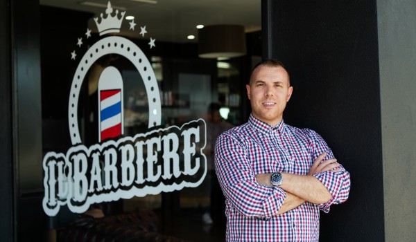 Barber in front of his store
