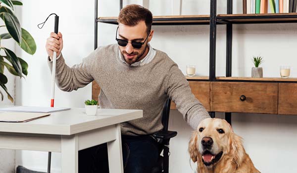 Person with vision impairment with support dog